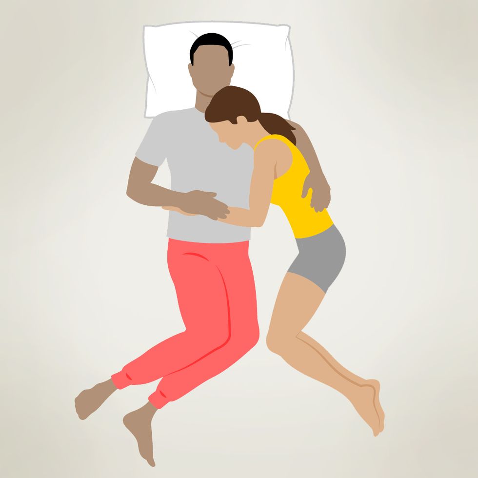 An illustration of a couple cuddling in the half-spooning position. The person in the gray shirt is lying on their back with one arm around the person in the yellow shirt, who is resting their head on the other person's chest and has their arm draped across their midsection. Both individuals appear to be relaxed and comfortable, sharing a close and intimate embrace.